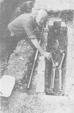 Richard Lewis excavating a skeleton, Lewes