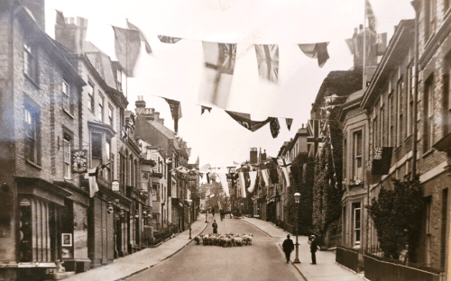 Sheep and flags on School Hill, lewes, postcard