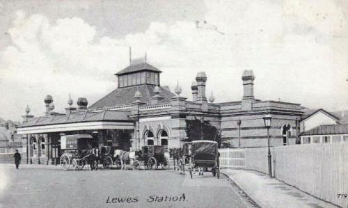 Horse-drawn traffic queueing at Lewes Railway Station, postcard by W. Brooker, posted November 1908